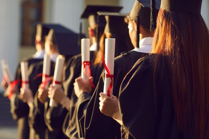 Graduation party checklist: students holding their diplomas